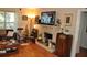 Comfortable living room with brick fireplace, TV, and cozy furniture at 1711 30Th W St, Bradenton, FL 34205