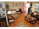 Open living room featuring hardwood floors, bench seating, and a red front door at 1711 30Th W St, Bradenton, FL 34205