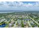 A panoramic aerial view showcases the residential neighborhood surrounded by lush greenery and serene lakes at 1727 88Th Nw Ct, Bradenton, FL 34209
