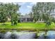 This backyard features a screened-in lanai overlooking a tranquil pond, perfect for relaxation and enjoying nature at 1727 88Th Nw Ct, Bradenton, FL 34209