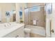 Bright bathroom offering tiled shower and tub with safety handrail at 1727 88Th Nw Ct, Bradenton, FL 34209