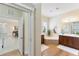 Bathroom view showcases a soaking tub with stone detail, wood cabinetry, and an adjoining room at 1727 88Th Nw Ct, Bradenton, FL 34209