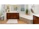 A stylish bathroom features a garden tub, dark wood cabinets, and a large window overlooking the outdoors at 1727 88Th Nw Ct, Bradenton, FL 34209