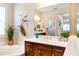 Bathroom vanity featuring wood cabinets, white countertops, and a large mirror, complemented by unique decor accents at 1727 88Th Nw Ct, Bradenton, FL 34209