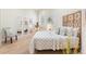 Inviting bedroom with natural light, hardwood floors, and a decorative screen headboard offers a serene retreat at 1727 88Th Nw Ct, Bradenton, FL 34209