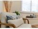 Cozy bedroom with comfortable chair, throw pillows, and bench seat in front of the window at 1727 88Th Nw Ct, Bradenton, FL 34209
