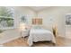 Cozy bedroom featuring a decorative screen headboard, hardwood floors, and a sunny window for a peaceful atmosphere at 1727 88Th Nw Ct, Bradenton, FL 34209