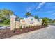 The Wisteria Park community entrance features a stone sign with manicured flower beds at 1727 88Th Nw Ct, Bradenton, FL 34209