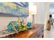 A wooden console table with decorative glass orbs, leafy accents, and a modern lamp for a stylish entryway at 1727 88Th Nw Ct, Bradenton, FL 34209