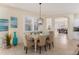 Bright dining room featuring beachy accents, modern light fixture and shutters at 1727 88Th Nw Ct, Bradenton, FL 34209