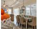 Light-filled dining room with tray ceiling, shutters, and stylish light fixture at 1727 88Th Nw Ct, Bradenton, FL 34209