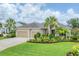 Charming single-story home with a well-manicured lawn, tropical landscaping and a two car garage at 1727 88Th Nw Ct, Bradenton, FL 34209