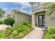 Inviting front entrance featuring a well-manicured garden and attractive neutral exterior at 1727 88Th Nw Ct, Bradenton, FL 34209
