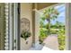 Charming front porch detail overlooking a lush, colorful garden and serene neighborhood at 1727 88Th Nw Ct, Bradenton, FL 34209