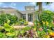 Lush landscaping and a stone walkway leading to the entrance of this charming home at 1727 88Th Nw Ct, Bradenton, FL 34209