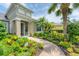 Beautiful home exterior with tropical landscaping, paver walkway, and lush, colorful garden at 1727 88Th Nw Ct, Bradenton, FL 34209