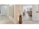 Wide hallway with decorative mirrors, bamboo plant, and views into the open-concept living and dining areas at 1727 88Th Nw Ct, Bradenton, FL 34209