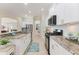 Bright kitchen features white cabinetry, granite countertops, and stainless steel appliances at 1727 88Th Nw Ct, Bradenton, FL 34209