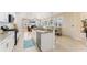 Open-concept kitchen with stainless steel appliances, granite countertops, and seamless flow to dining and living areas at 1727 88Th Nw Ct, Bradenton, FL 34209