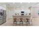 Modern kitchen with white cabinets, granite counters, and stainless steel appliances with island seating for entertaining at 1727 88Th Nw Ct, Bradenton, FL 34209