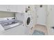 Well-lit laundry room with modern washer and dryer and ample storage cabinets at 1727 88Th Nw Ct, Bradenton, FL 34209