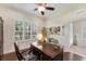 Office featuring a classic wooden desk, shutters, and French doors at 1727 88Th Nw Ct, Bradenton, FL 34209
