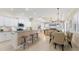 Open-concept kitchen, dining, and living areas featuring bar seating, stainless steel appliances, and coastal decor at 1727 88Th Nw Ct, Bradenton, FL 34209