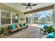 Inviting covered patio with comfortable seating, ceiling fan, and serene pool view at 1727 88Th Nw Ct, Bradenton, FL 34209