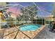 Inviting screened-in pool area with lovely lake views, brick pavers, and comfortable seating at 1727 88Th Nw Ct, Bradenton, FL 34209