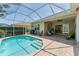 Captivating view of the pool and outdoor lounge area, perfect for relaxation and entertainment at 1727 88Th Nw Ct, Bradenton, FL 34209