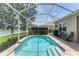 Beautiful backyard pool with screened enclosure and picturesque lakeside view, ideal for outdoor enjoyment at 1727 88Th Nw Ct, Bradenton, FL 34209