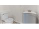 Cozy bathroom with gray vanity, sink, faucet, and modern toilet at 2070 Carpetgreen St, Port Charlotte, FL 33948