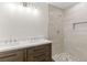 Updated bathroom features a double sink vanity and a tiled walk-in shower with a mosaic floor at 2070 Carpetgreen St, Port Charlotte, FL 33948