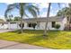 Charming single-story home with well-maintained front yard and beautiful landscaping at 2070 Carpetgreen St, Port Charlotte, FL 33948