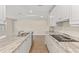 Gourmet kitchen with granite countertops, sleek stainless steel appliances, wood flooring, and ample storage at 2070 Carpetgreen St, Port Charlotte, FL 33948