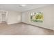 Bright and airy living room featuring sleek wood floors, a large window, and freshly painted walls at 2070 Carpetgreen St, Port Charlotte, FL 33948
