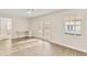 Open living room with abundant natural light, desk space and double glass doors leading to outside at 2070 Carpetgreen St, Port Charlotte, FL 33948