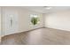 Inviting living room with wood flooring, natural light, and a freshly painted interior at 2070 Carpetgreen St, Port Charlotte, FL 33948