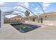 This beautiful pool has blue tile and is surrounded by a screened enclosure at 2070 Carpetgreen St, Port Charlotte, FL 33948