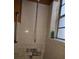 Shower with white tiles, chrome fixtures, and an orange wall at 220 29Th E St, Palmetto, FL 34221