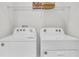 Convenient laundry area with a modern, white washer and dryer, offering a clean aesthetic at 2457 Mellow Ln, Clearwater, FL 33765