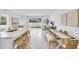 Open-concept living space with island seating, dining area, and a view of the backyard at 2457 Mellow Ln, Clearwater, FL 33765