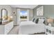 Bright bedroom with a large window, white bedding, and stylish decor at 2469 Mellow Ln, Clearwater, FL 33765