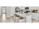 Modern kitchen with white cabinets, stainless steel appliances, and a breakfast bar at 2473 Mellow Ln, Clearwater, FL 33765