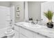 Modern bathroom with a single sink vanity, marble countertop, and shower-tub combination with white tile at 2477 Mellow Ln, Clearwater, FL 33765