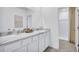 Bathroom features a double sink vanity with marble counters, white cabinetry, and a shower stall at 2481 Mellow Ln, Clearwater, FL 33765