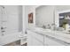 Bathroom features white cabinets, marble counters, and a combined shower and tub, perfect for relaxation at 2481 Mellow Ln, Clearwater, FL 33765