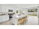Bright kitchen features stainless steel appliances, an island with bar seating, and plenty of white cabinet storage at 2481 Mellow Ln, Clearwater, FL 33765