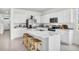 Modern kitchen with white cabinets, a marble island with barstools, and stainless steel appliances at 2481 Mellow Ln, Clearwater, FL 33765