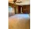 Cozy living room with wood paneled walls and neutral carpeting at 2712 52Nd Avenue W Ter, Bradenton, FL 34207